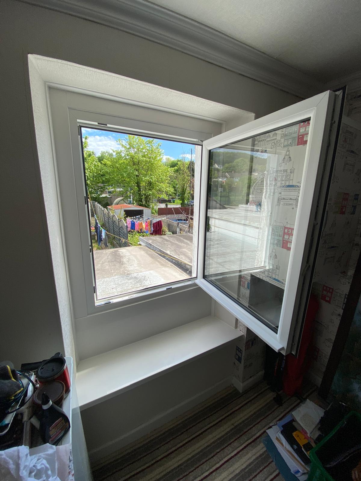 White PVCu window shown open from inside a bedroom