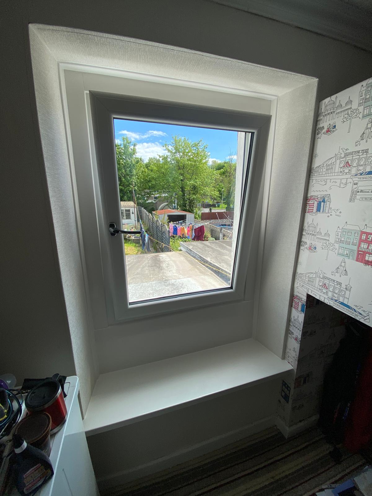 White PVCu casement window viewed from inside with a deep sill