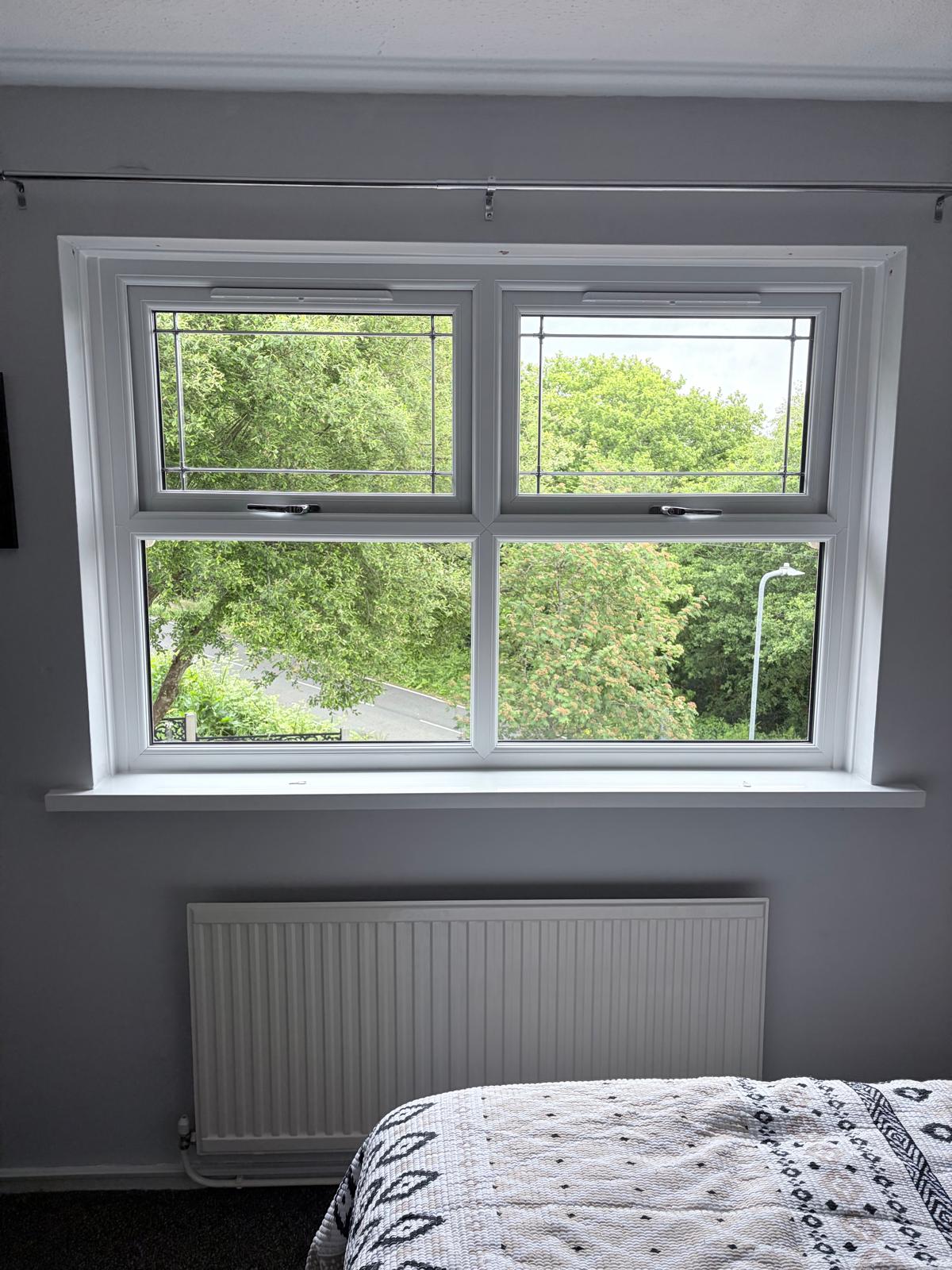 White PVCu bedroom window with top-opening vents and lead detail