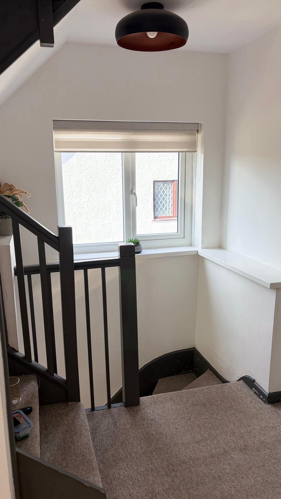 White PVCu landing window beside a staircase